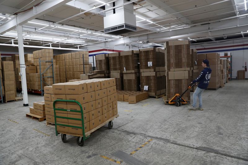 An employee of Defender Safety moves products inside their warehouse