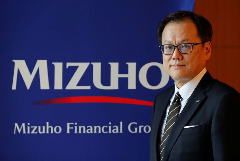 Mizuho Financial Group’s Chief Executive Officer Tatsufumi Sakai poses for