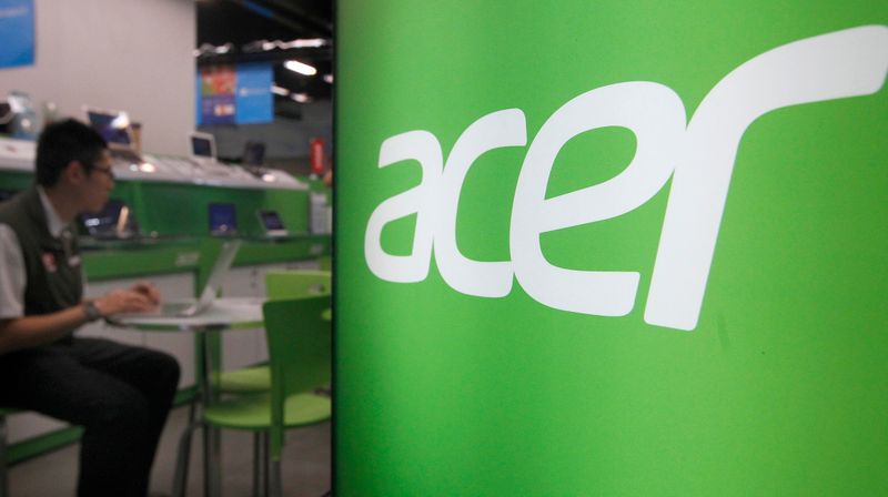 FILE PHOTO: A shop attendant sits in an Acer booth