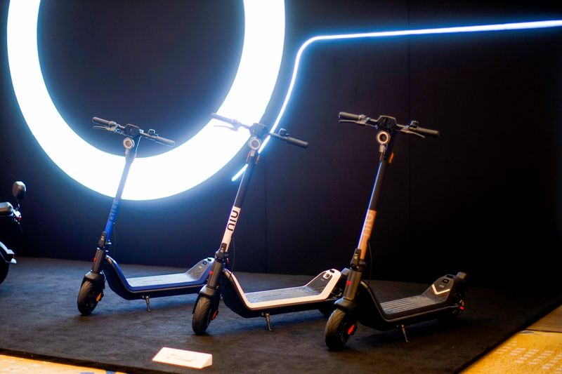 NIU Technologies’ kick scooters are displayed at a media conference