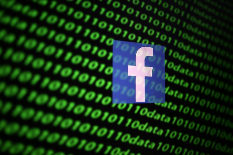 The Facebook logo and binary cyber codes are seen in