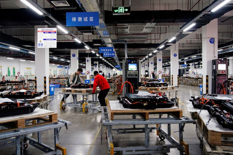 Employees work on the production line of electric vehicle (EV)