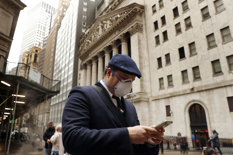 FILE PHOTO: FILE PHOTO: A man walks on Wall Street