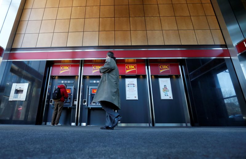 FILE PHOTO: Pedestrians use the CIBC ATM machines in Montreal