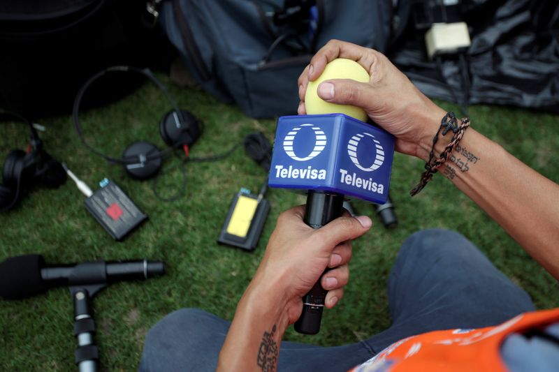 A technician holds a microphone of Mexican broadcaster Televisa before