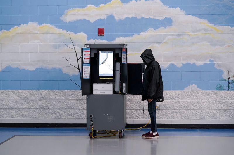 FILE PHOTO: Voters cast their ballots in Georgia’s Senate runoff