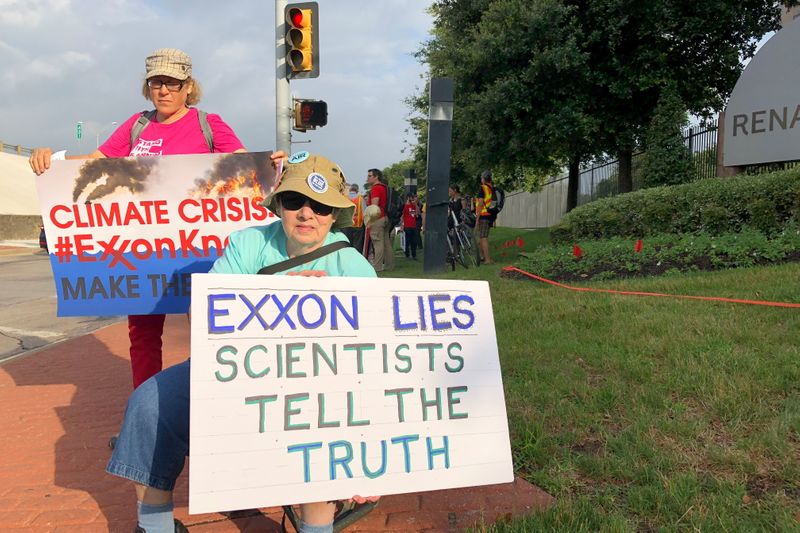 FILE PHOTO: Blanca Gonzales and Susan Cooper protest ExxonMobil’s climate