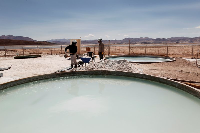 FILE PHOTO: Galaxy Resources workers shovel halite concentrate at the