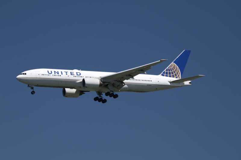 A United Airlines Boeing 777-200, with Tail Number N796UA, lands