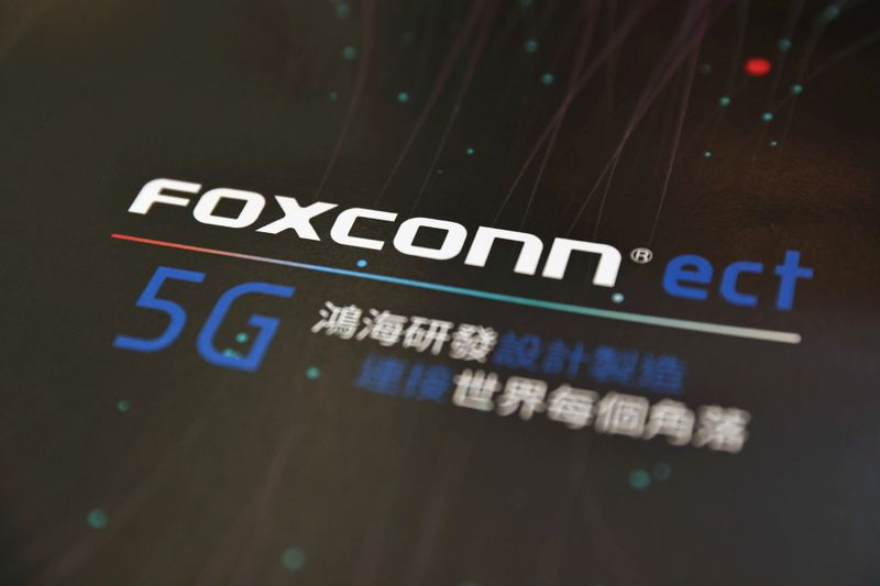 FILE PHOTO: A poster with a logo of Foxconn is