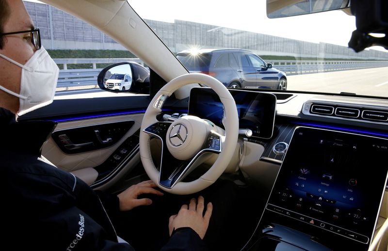 FILE PHOTO: An employee demonstrates steering by autonomous driving system