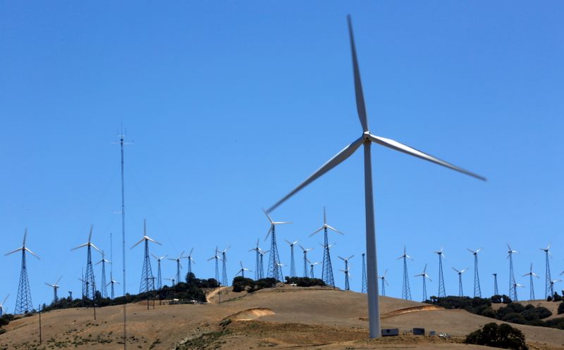 FILE PHOTO: A GE 1.6-100 wind turbine (front R) is