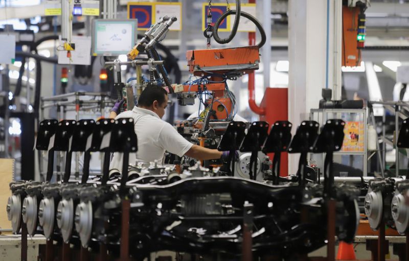 An employee works on the production line of the Volkswagen