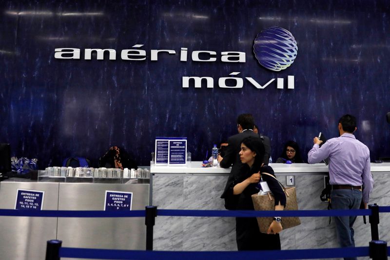The logo of America Movill is seen on the wall