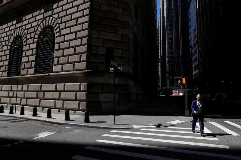 A man walks by the Federal Reserve Bank of New