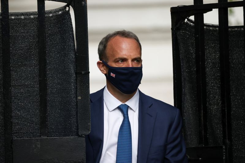 Britain’s Foreign Secretary Dominic Raab walks outside Downing Street, in