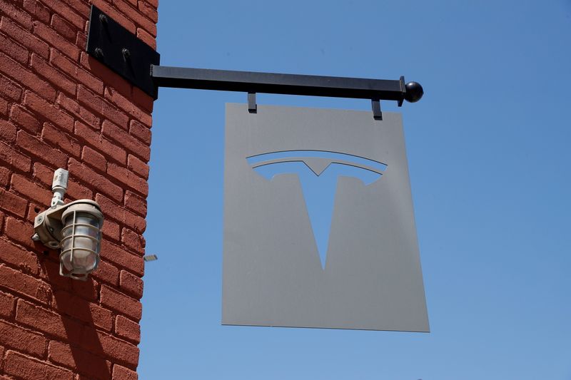 The TESLA logo is seen outside a dealership in the