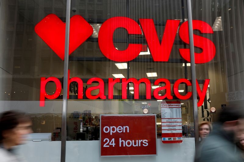 FILE PHOTO: People walk by a CVS Pharmacy store in
