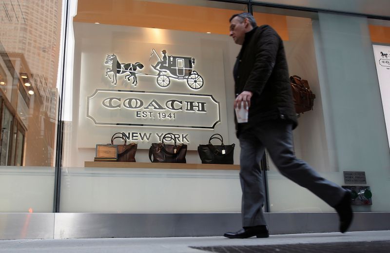 FILE PHOTO: A man walks past a Coach store on