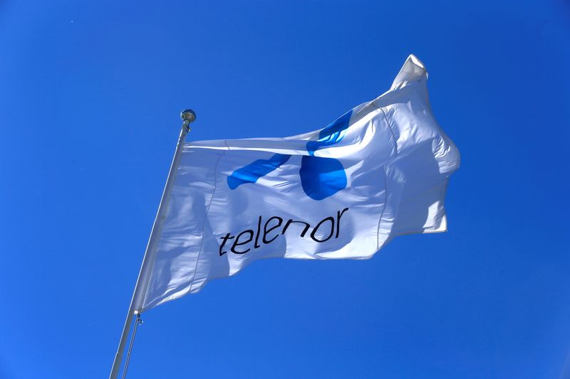 FILE PHOTO: Telenor flag flutters next to the company’s headquarters