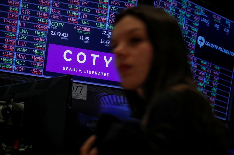 A screen displays the logo and trading information for Coty