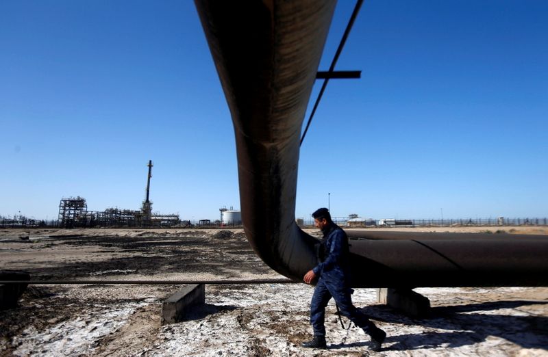 FILE PHOTO: A policeman walks at West Qurna-1 oil field,