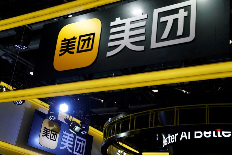 FILE PHOTO: Signs of Meituan are seen at its booth