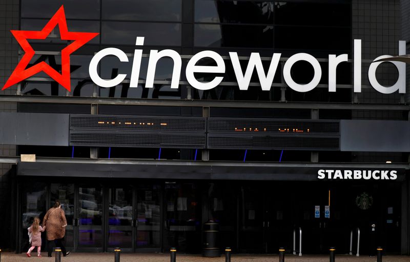FILE PHOTO: People enter a Cineworld cinema following the outbreak