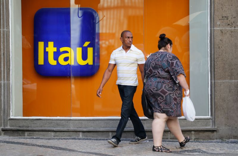 FILE PHOTO: People walk past an Itau branch office in