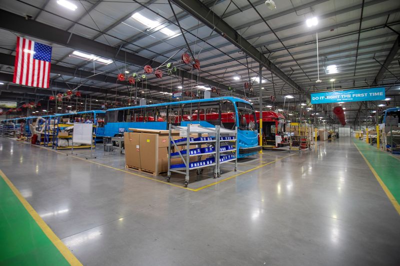 Buses are shown being built at the BYD electric bus