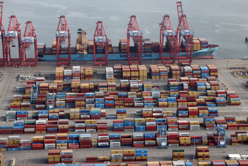FILE PHOTO: Shipping containers are unloaded from a ship at