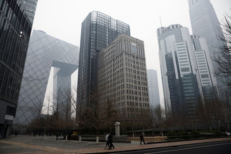 People walk at the Beijing’s central business district (CBD), on