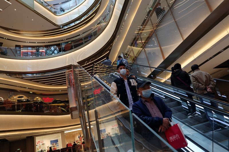 People visit a newly opened shopping mall in Beijing