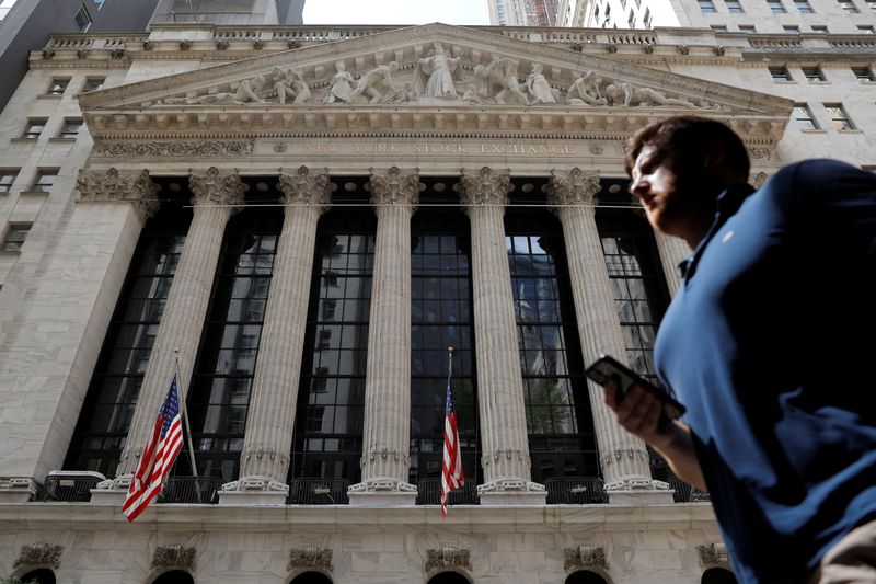 A person walks by the New York Stock Exchange (NYSE)