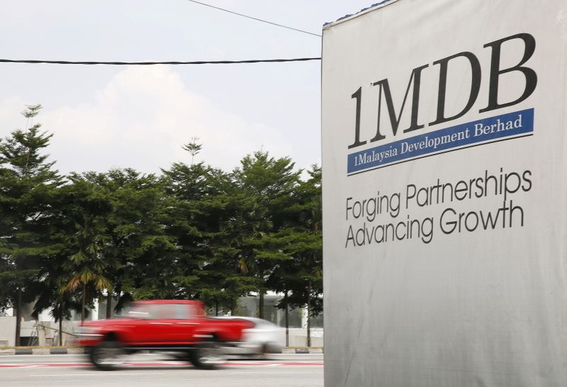 FILE PHOTO: Traffic passes a 1Malaysia Development Berhad (1MDB) billboard