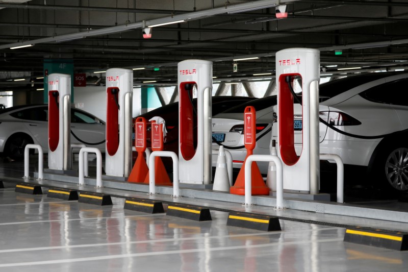 FILE PHOTO: Tesla electric vehicles are charged at a Tesla