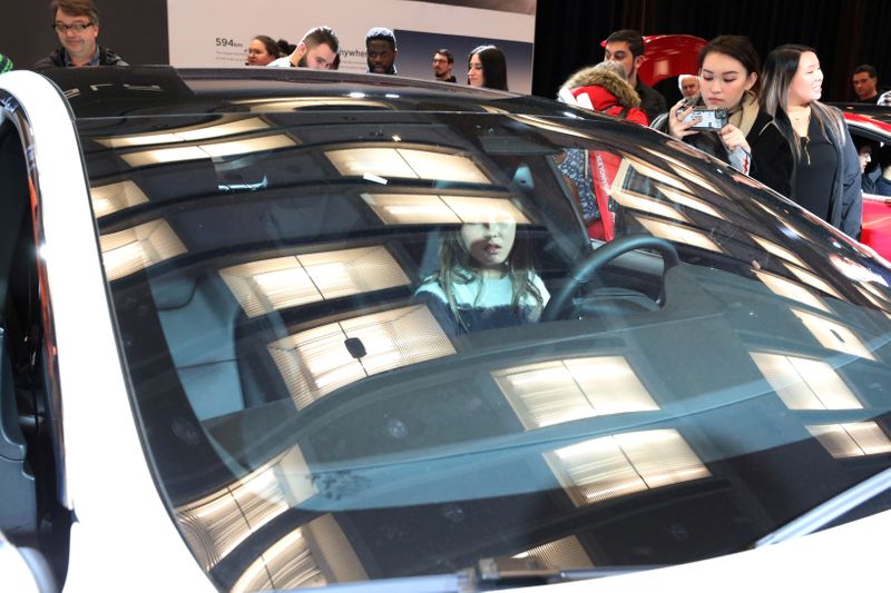 FILE PHOTO: A visitor sits in the Tesla Model S