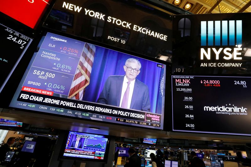 A screen displays the Federal Reserve Chair Powell on the