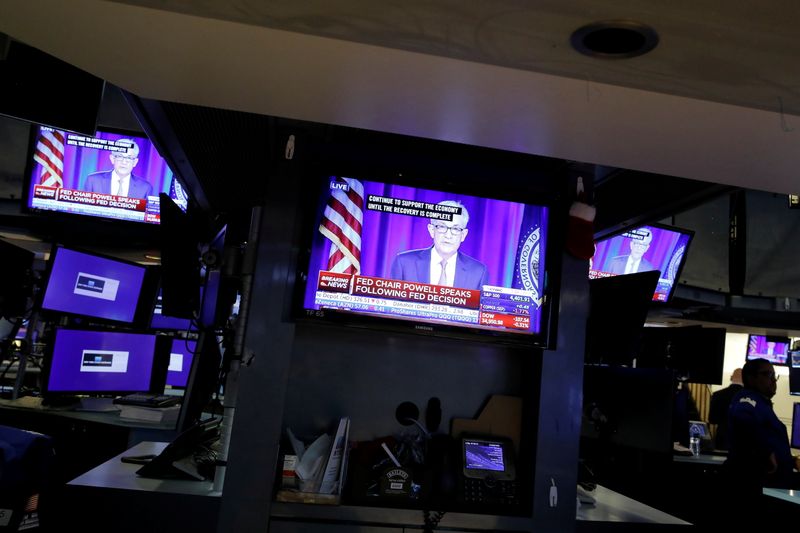 A screen displays a statement by Federal Reserve Chair Powell