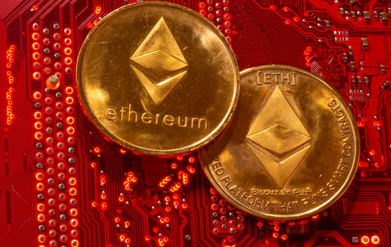 Representations of cryptocurrencies Ethereum are placed on PC motherboard in