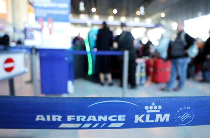 FILE PHOTO: Passengers wait at the Air France desk at