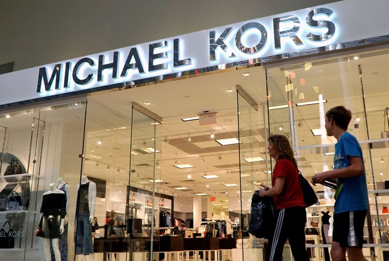 FILE PHOTO: People walk by a Michael Kors store in