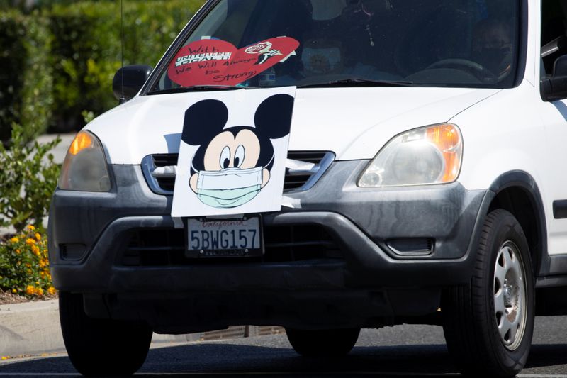 Disney cast members stage a car caravan outside Disneyland California,