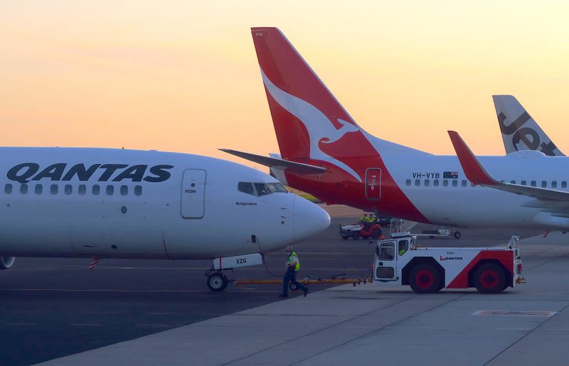 Workers are seen near Qantas Airways, Australia’s national carrier, Boeing