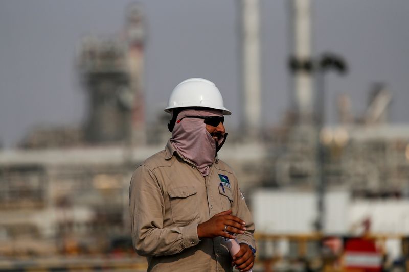 FILE PHOTO: An employee looks on at Saudi Aramco oil