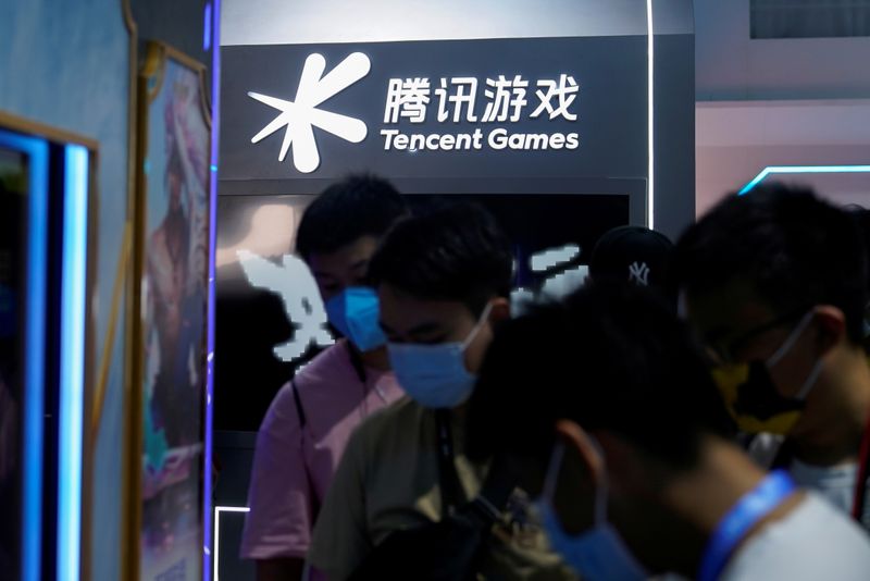 FILE PHOTO: Visitors are seen at the Tencent Games booth