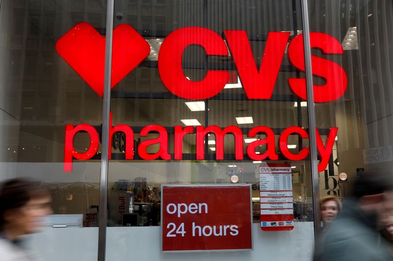 FILE PHOTO: People walk by a CVS Pharmacy store in