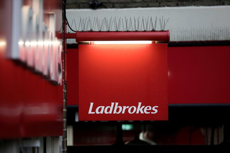 FILE PHOTO: A sign hangs outside a branch of Ladbrokes