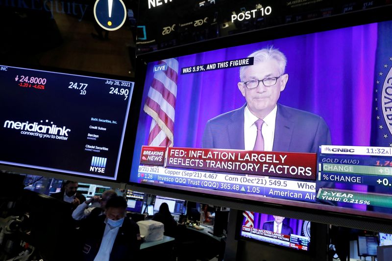 FILE PHOTO: A screen displays a statement by Federal Reserve