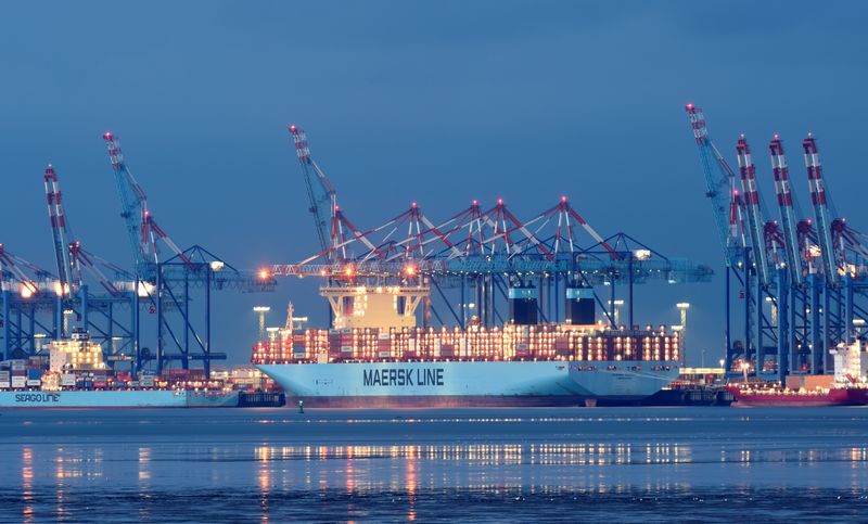 Maersk container ship is loaded at a harbour terminal in